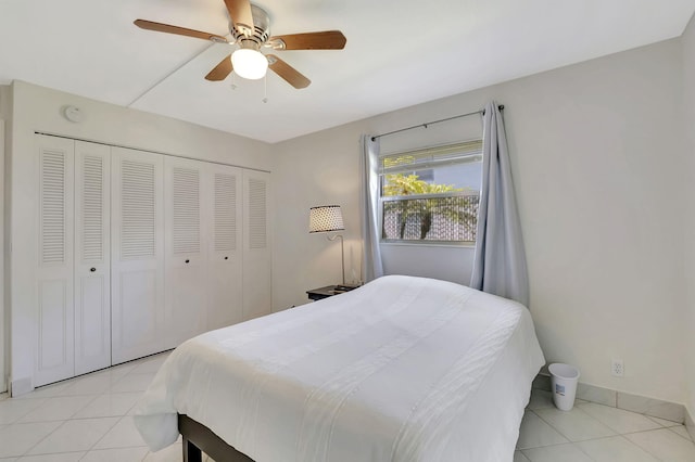 tiled bedroom featuring ceiling fan and a closet