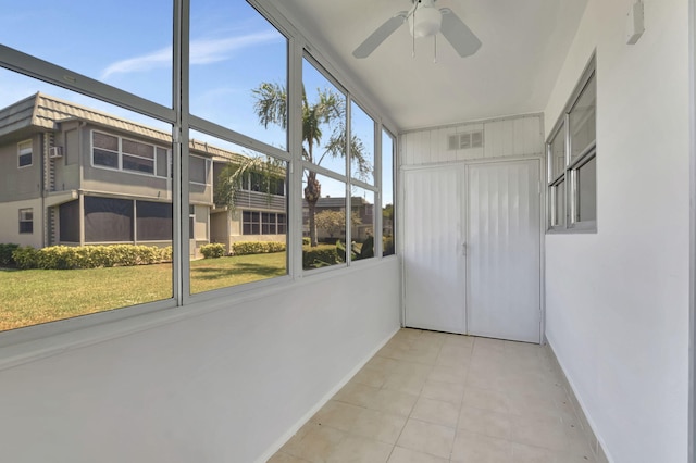 unfurnished sunroom with ceiling fan and plenty of natural light