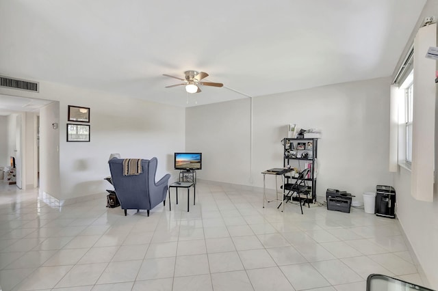 living area featuring ceiling fan and light tile patterned floors