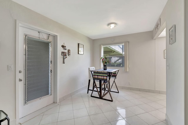 dining space featuring light tile patterned flooring