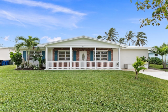 single story home featuring covered porch and a front yard