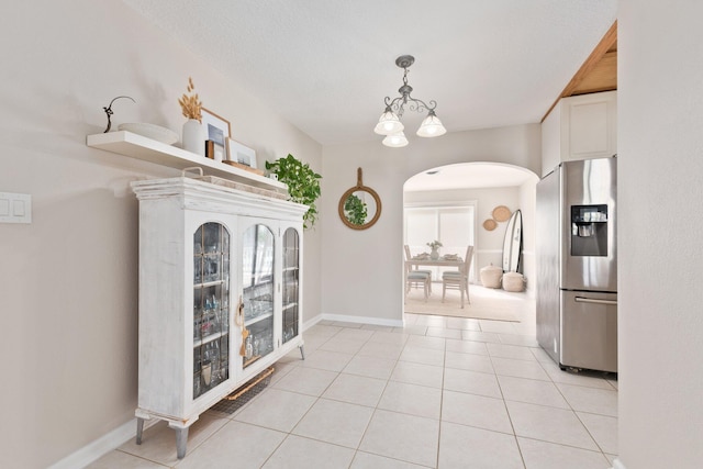 interior space featuring a chandelier and light tile patterned floors