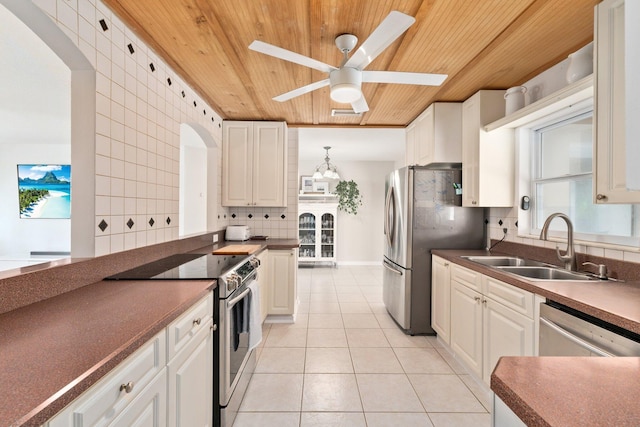 kitchen featuring white cabinets, sink, decorative backsplash, ceiling fan, and stainless steel appliances