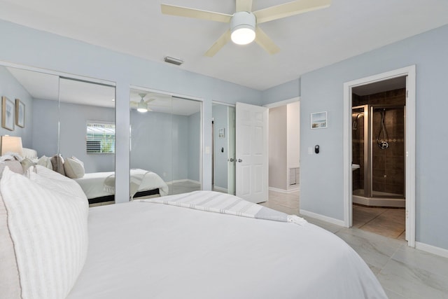 bedroom featuring connected bathroom, multiple closets, and ceiling fan