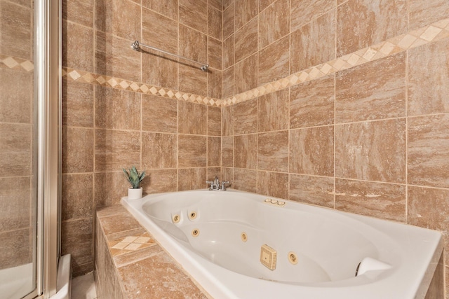 bathroom featuring independent shower and bath and tile walls