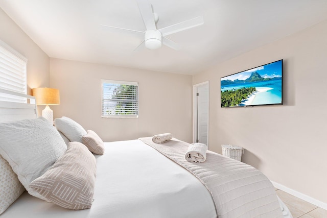 tiled bedroom featuring ceiling fan