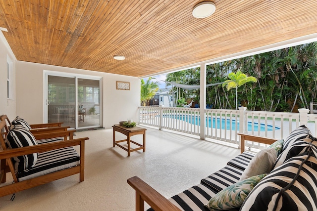 carpeted living room featuring wooden ceiling and plenty of natural light