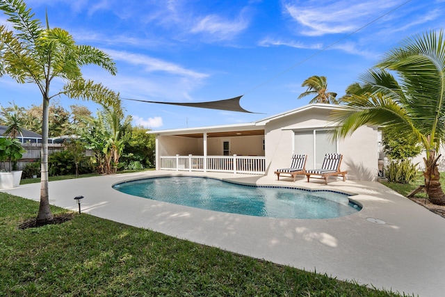 view of swimming pool with a yard and a patio area