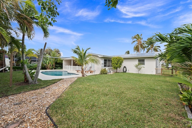 back of house with a lawn and a patio