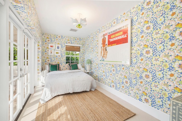 240 El Dorado Ln, Palm Beach, FL 33480 - bedroom featuring wallpapered walls, french doors, and baseboards