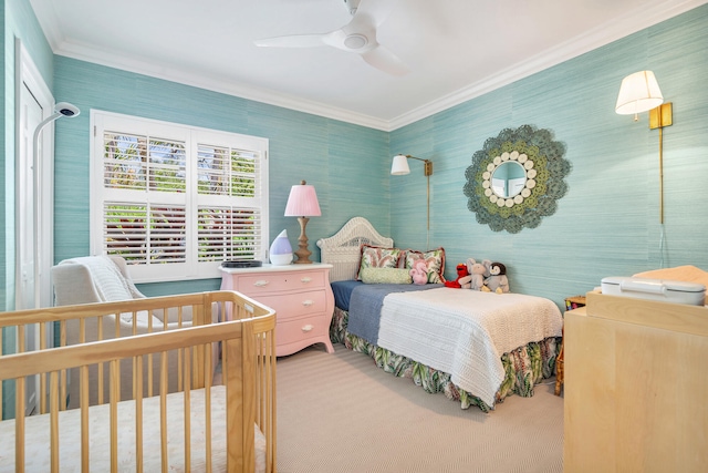 carpeted bedroom with ceiling fan and ornamental molding