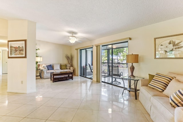 living room with a textured ceiling, ceiling fan, and light tile patterned flooring