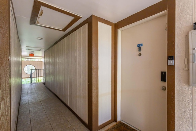 hall featuring wooden walls