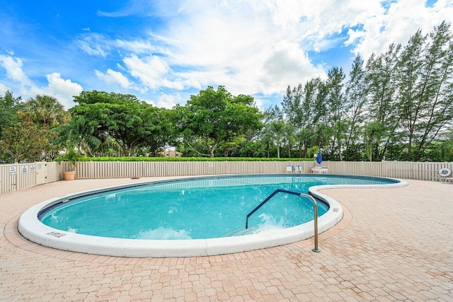 view of swimming pool featuring a patio area