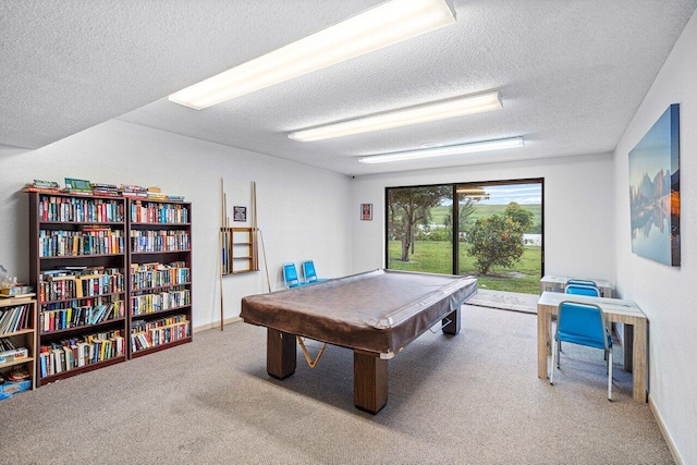 recreation room with billiards, a textured ceiling, and carpet