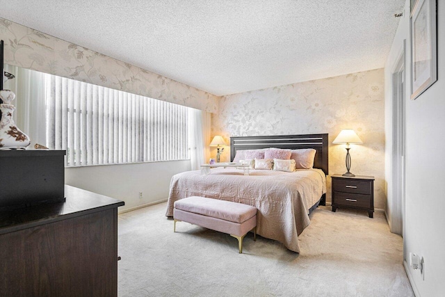 carpeted bedroom with multiple windows and a textured ceiling