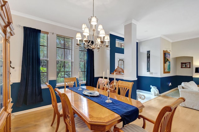 dining space with ornamental molding, ornate columns, a notable chandelier, and light hardwood / wood-style floors