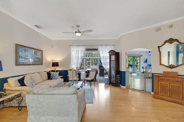 living room featuring ceiling fan, light hardwood / wood-style flooring, and ornamental molding