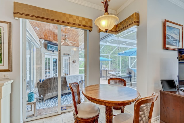 dining space with ornamental molding, light tile patterned flooring, a wealth of natural light, and ceiling fan