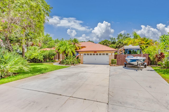 view of front of house with a garage and a front lawn