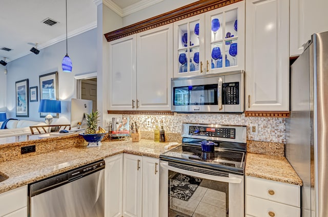 kitchen featuring tasteful backsplash, crown molding, stainless steel appliances, white cabinetry, and hanging light fixtures