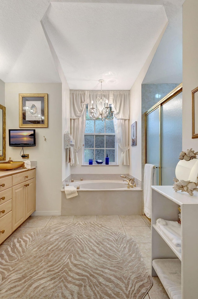 bathroom featuring vanity, independent shower and bath, tile patterned flooring, and a notable chandelier