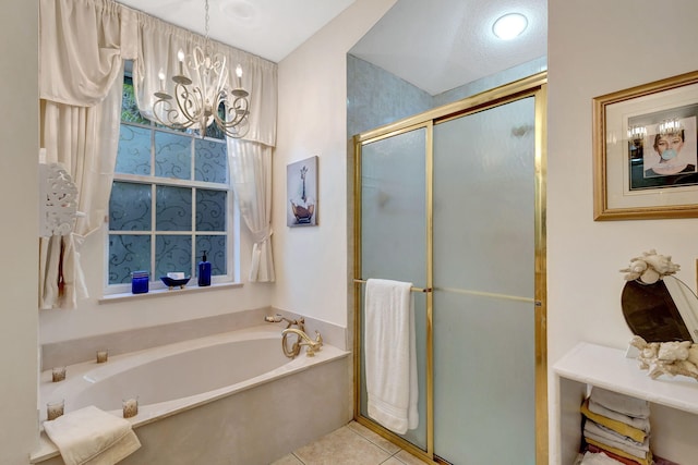 bathroom with tile patterned flooring, plus walk in shower, and a notable chandelier