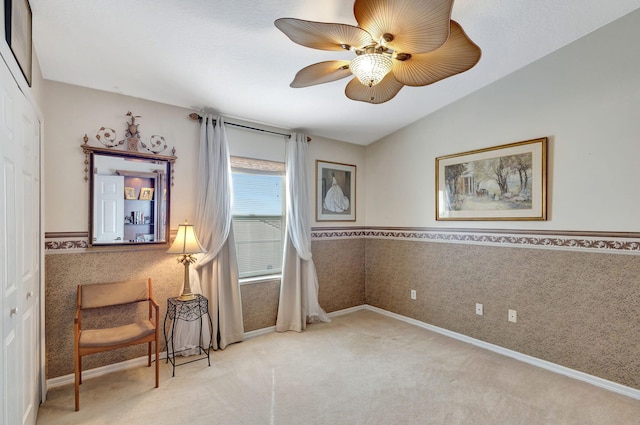 sitting room featuring carpet, vaulted ceiling, and ceiling fan