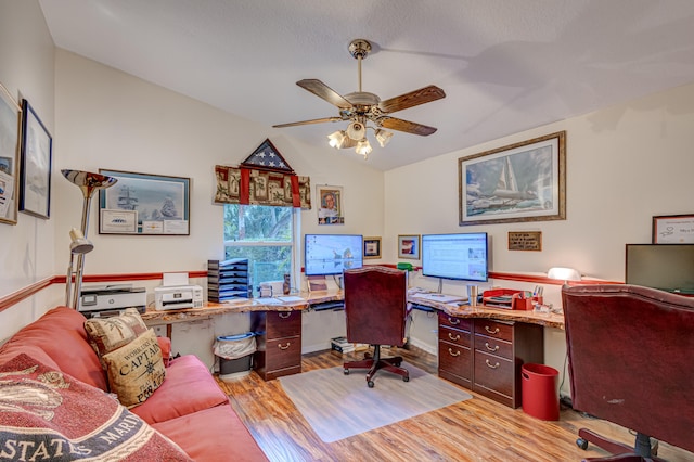 office space with ceiling fan, lofted ceiling, and light hardwood / wood-style floors