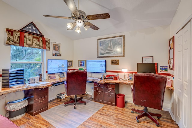 office area featuring light wood-type flooring, vaulted ceiling, and ceiling fan