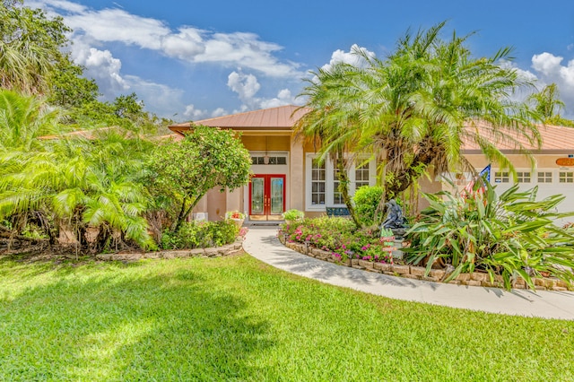 view of front of house featuring a front yard and french doors