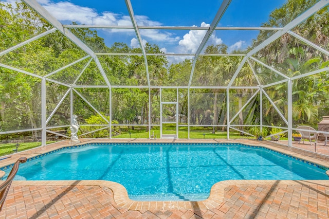 view of swimming pool featuring a lanai and a patio area