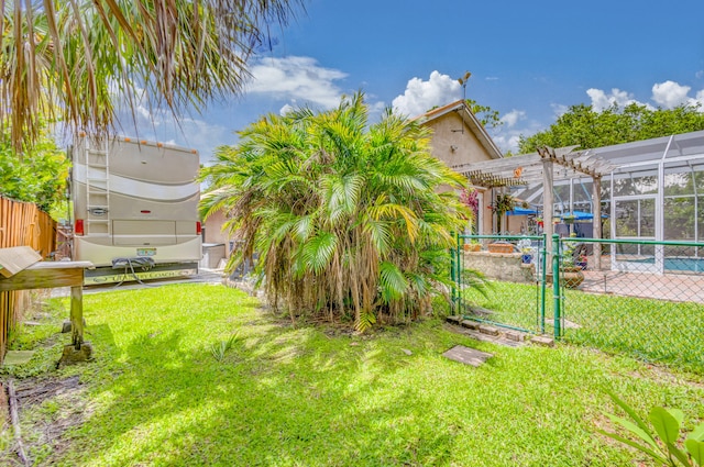 view of yard featuring a lanai and a swimming pool