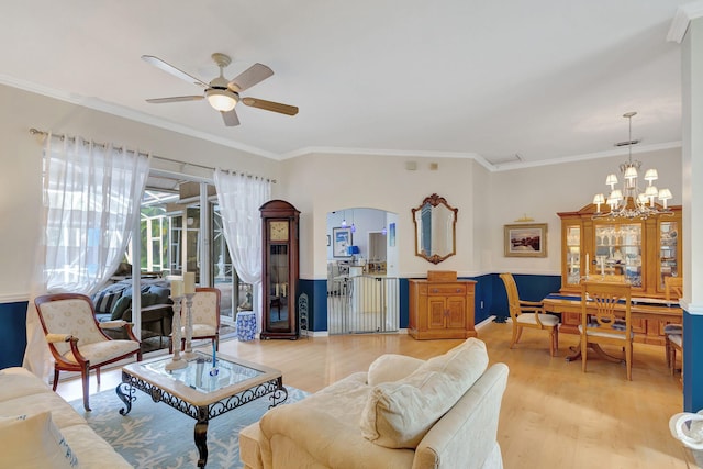 living room with light hardwood / wood-style floors, ceiling fan with notable chandelier, and ornamental molding