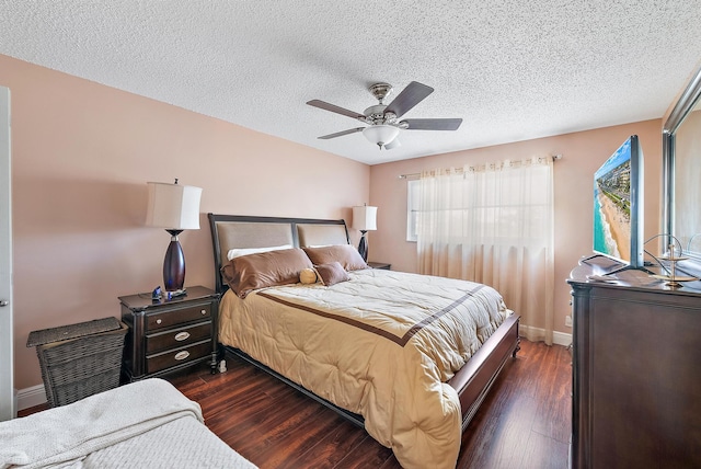 bedroom with a textured ceiling, dark hardwood / wood-style floors, and ceiling fan