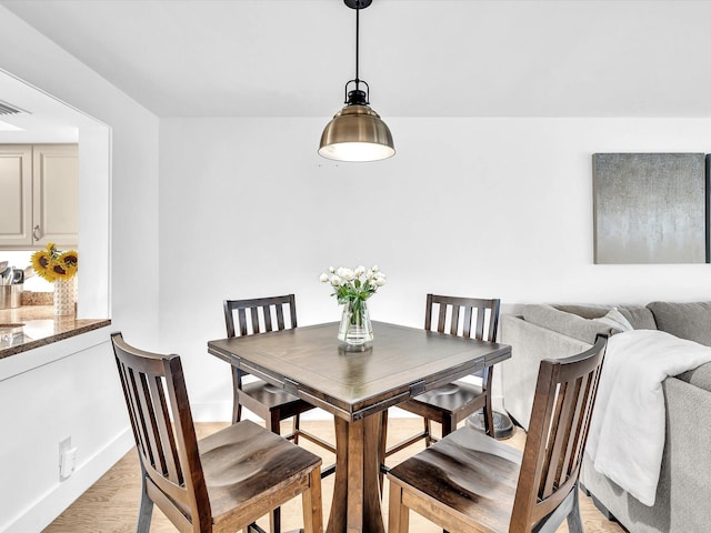 dining area featuring light wood-type flooring