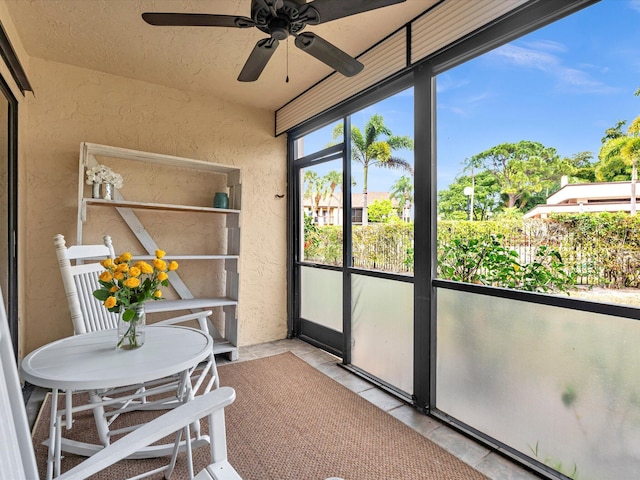 sunroom / solarium featuring ceiling fan