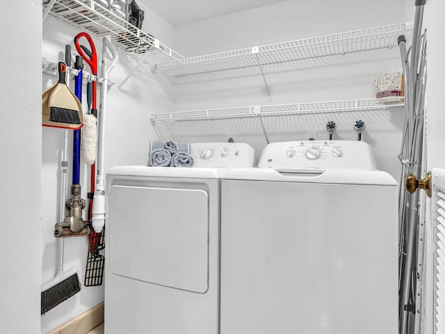 clothes washing area featuring washer and clothes dryer