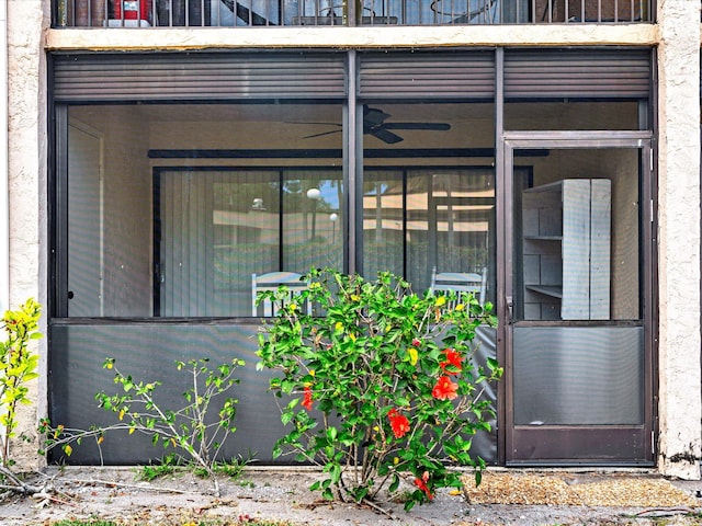 view of exterior entry with a balcony