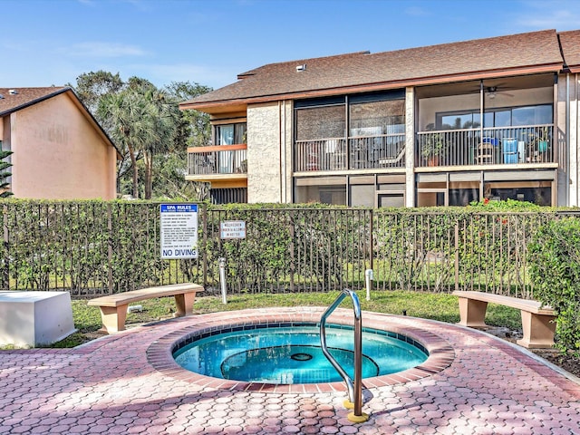 view of swimming pool featuring a hot tub