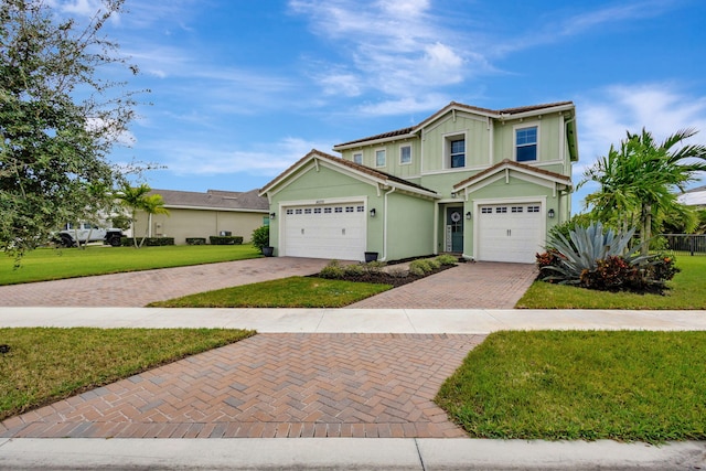 view of front of house featuring a garage and a front lawn