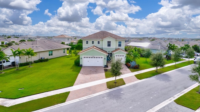 view of front of property with a garage and a front yard