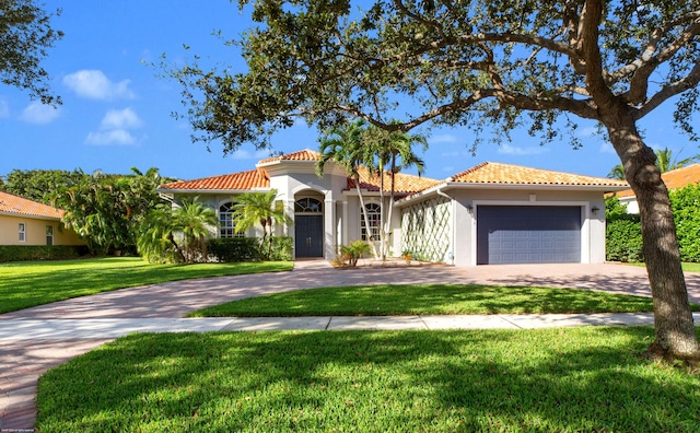 mediterranean / spanish-style house with a front yard and a garage