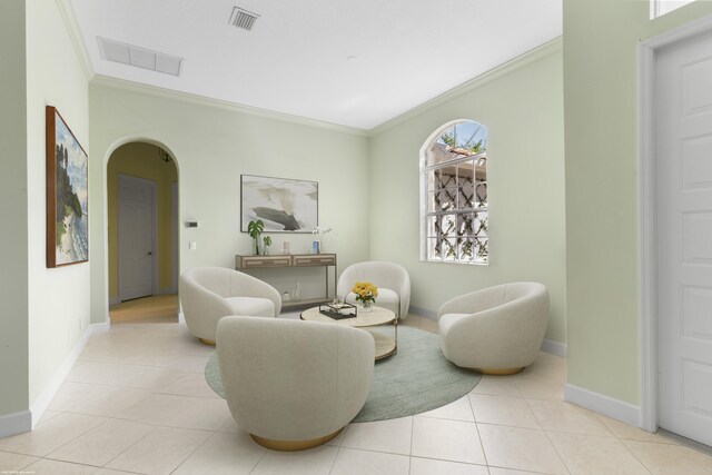 living room featuring a chandelier, ornamental molding, and light tile patterned flooring