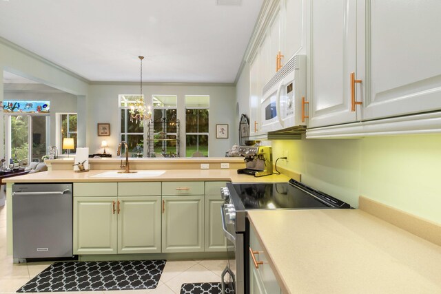 kitchen featuring crown molding, sink, hanging light fixtures, light tile patterned floors, and stainless steel appliances