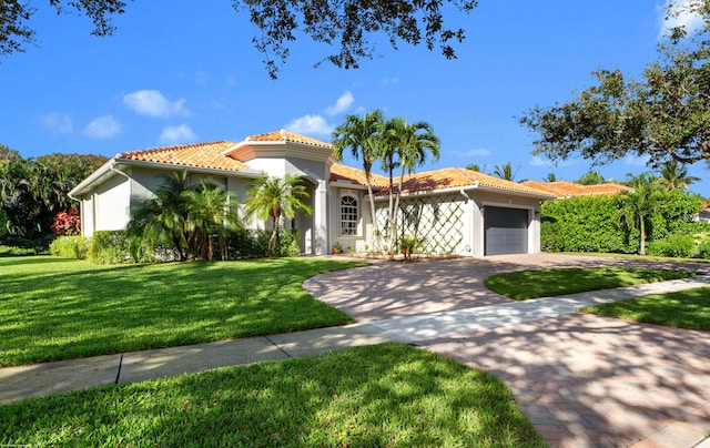 mediterranean / spanish-style home with a garage and a front yard