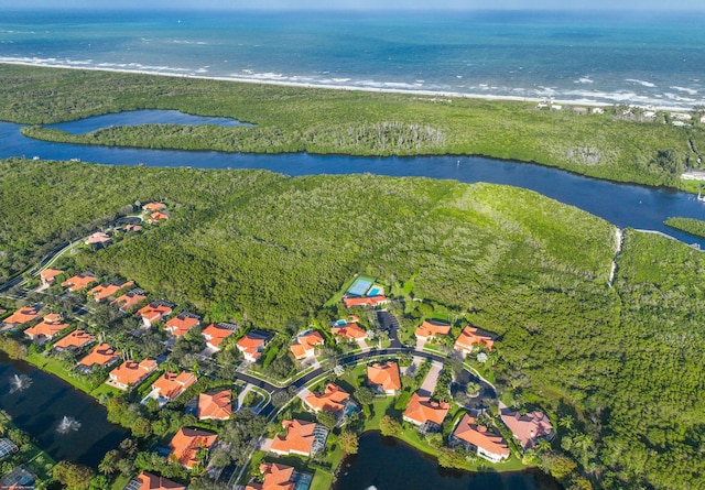 bird's eye view featuring a water view and a beach view