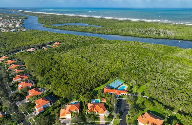 drone / aerial view with a water view and a beach view