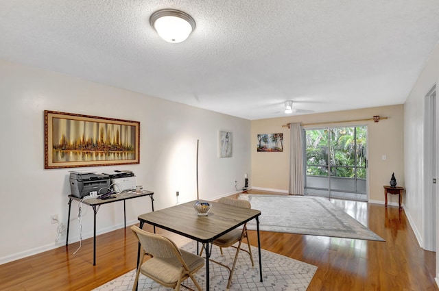 dining room featuring ceiling fan, a textured ceiling, and light hardwood / wood-style flooring