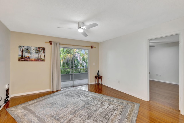 empty room with ceiling fan and wood-type flooring